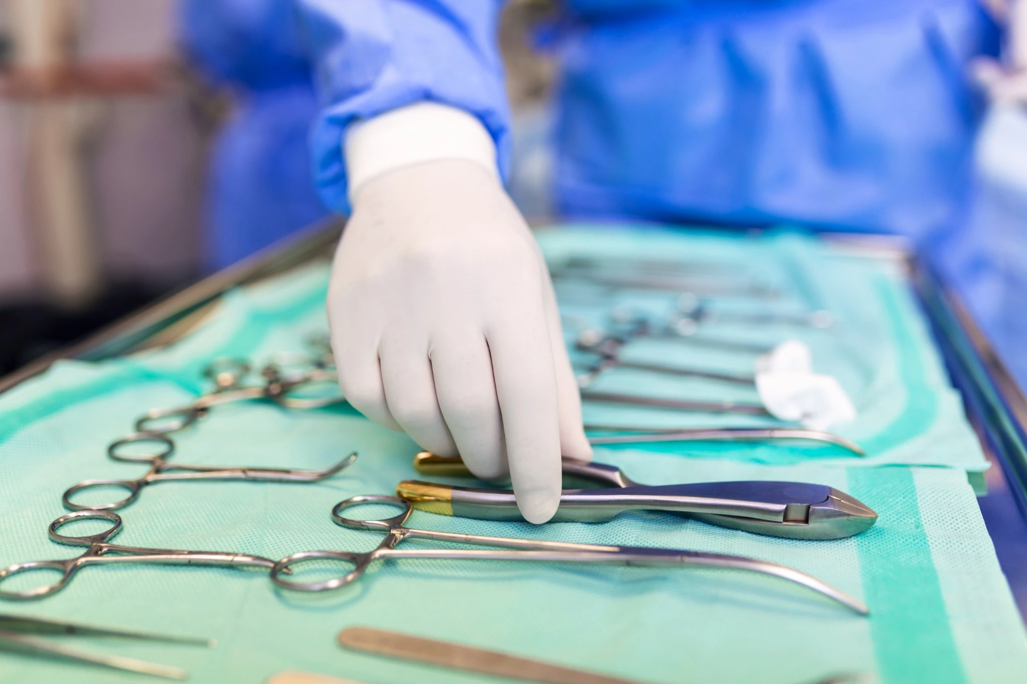 Surgeon selecting surgical instruments from a sterile tray